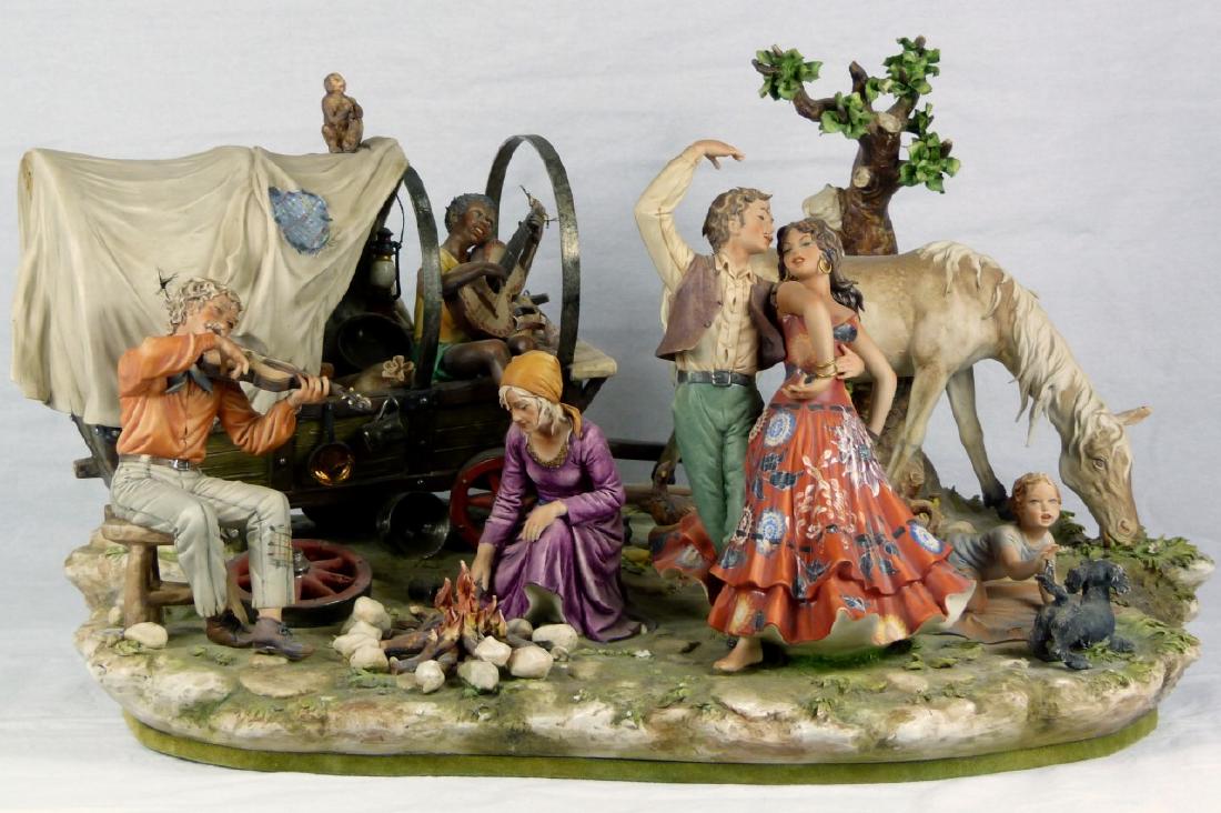 LARGE CAPODIMONTE 'GYPSY ENCAMPMENT' GROUPING: Large figural porcelain grouping sculpted by Sandro Maggioni for Capodimonte. Titled 'The Gypsy Encampment'. Signed, dated 1973 and holds crowned N mark. Measures 26" (66cm) x 16" (40.6cm) x 14 1/2" (