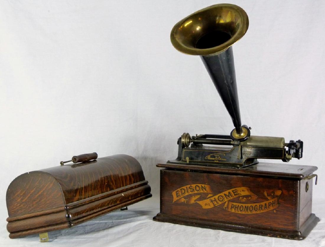 EDISON HOME PHONOGRAPH w HORN: Thomas Edison home phonograph. Marked to front of wood case and holds metal plaque to top of mechanism. Dome lid lifts open an locks closed on side. Serial H169740. Includes five cylinders, crank and