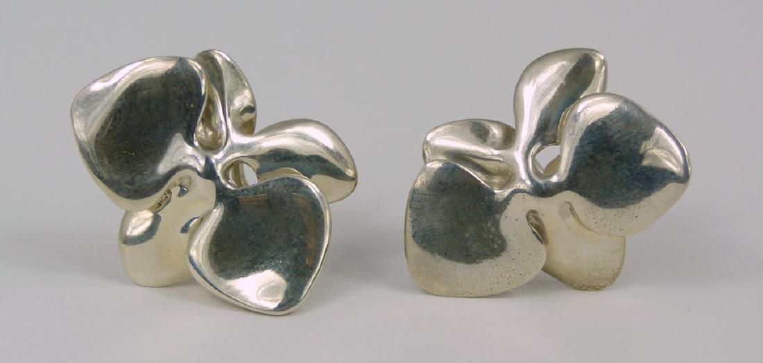 PR ANGELA CUMMINGS STERLING ORCHID EARRINGS: Pair of Angela Cummings sterling silver earrings with modern orchid design. Each marked Cummings, Sterling and dated 1984. Each measures 1 3/16" (3cm) length.