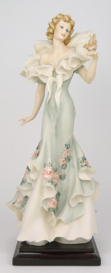 GIUSEPPE ARMANI 'PRETTY WOMAN' FIGURINE: Giuseppe Armani 'Pretty Woman' #1938C figure depicting a lady with bird. Marked to base and holds original labels to underside. Figurine measures 13 3/4" (35cm) height.