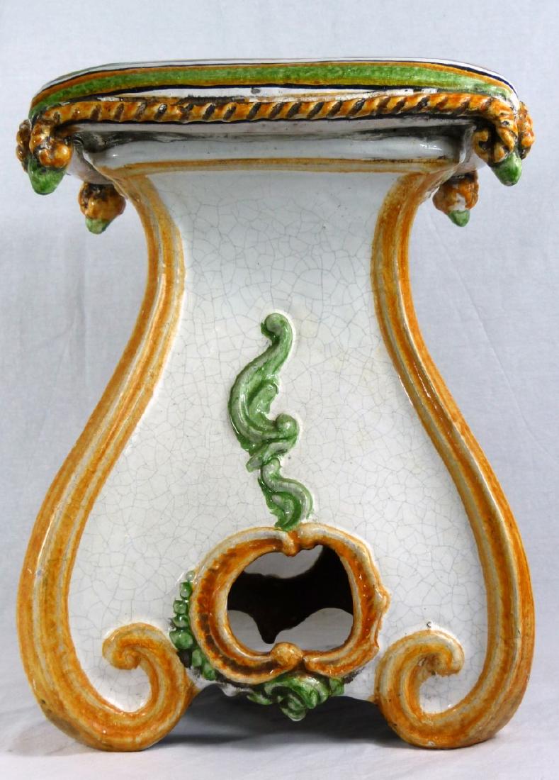 ITALIAN GLAZED POTTERY GARDEN SEAT: Italian glazed pottery garden stool with scrolled design and "pillow" top. Marked 'Made in Italy' to underside. Measures 17" (43cm) height.