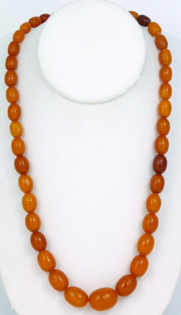 VINTAGE BUTTERSCOTCH BAKELITE BEADED NECKLACE: Vintage butterscotch bakelite necklace with graduated beads. Center bead measures approx 20mm length. Necklace measures 21 1/2" (54.5cm) overall length.