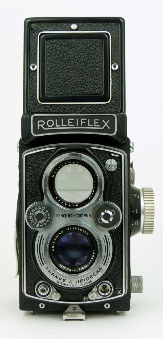 FRANKE & HEIDECKE ROLLEIFLEX CAMERA: Franke & Heidecke, Rolleiflex Camera with Carl Zeiss lens. Numbered 2032161. Includes fitted leather case and paperwork. Measures 6" (15.2cm) x 4 1/4" (11.2cm).