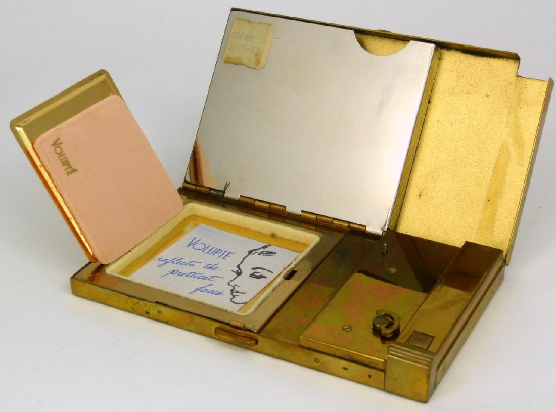 VOLUPTE COMPACT MUSIC BOX w ORIGINAL BOX: Volupte compact carry all with mirror, powder, lipstick and music box. Measures 5 1/4" (13.3cm) length. Includes case with carry handle and original box.