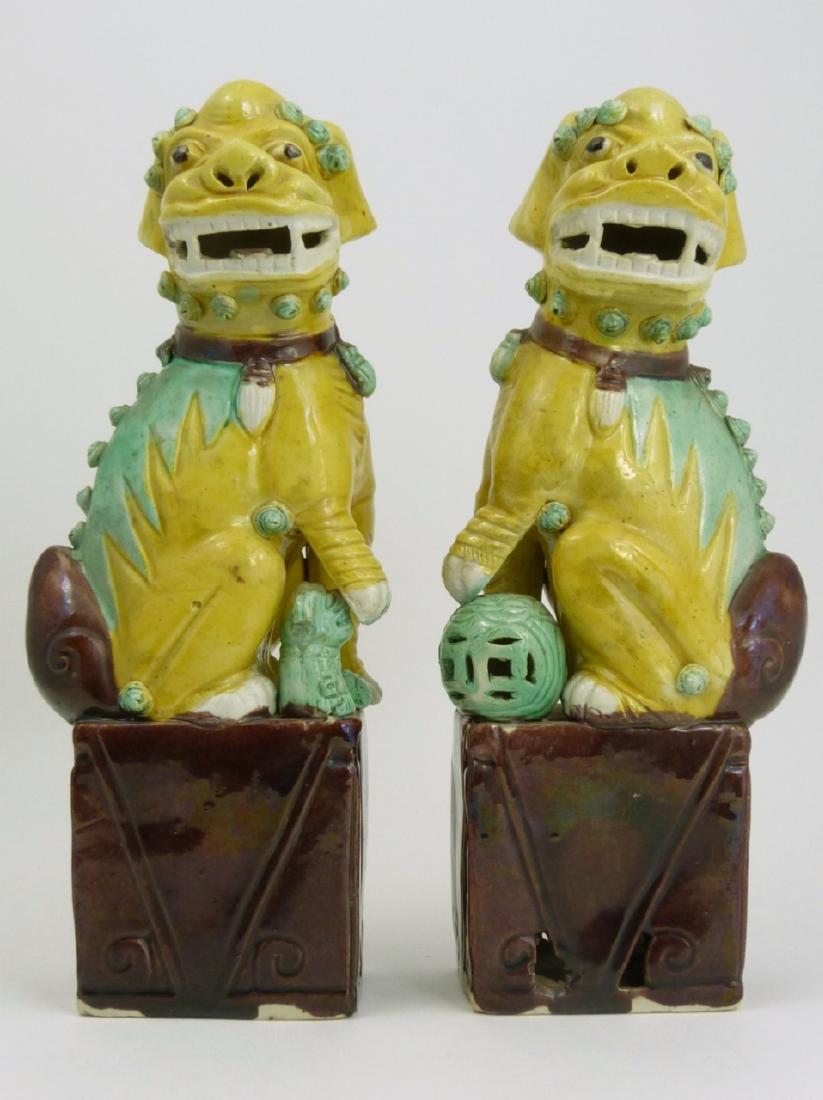 PR CHINESE GLAZED PORCELAIN FOO DOGS: Pair of Chinese glazed pottery foo dogs. Each measures 9 1/4" (23.5cm) height.