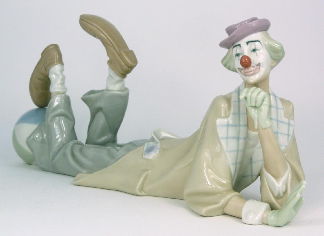 LLADRO 'RECLINING CLOWN w BALL' PORCELAIN FIGURINE: Lladro porcelain figure depicting a clown with ball #4618. Marked to underside. Measures 14 1/2" (36.8cm) length.