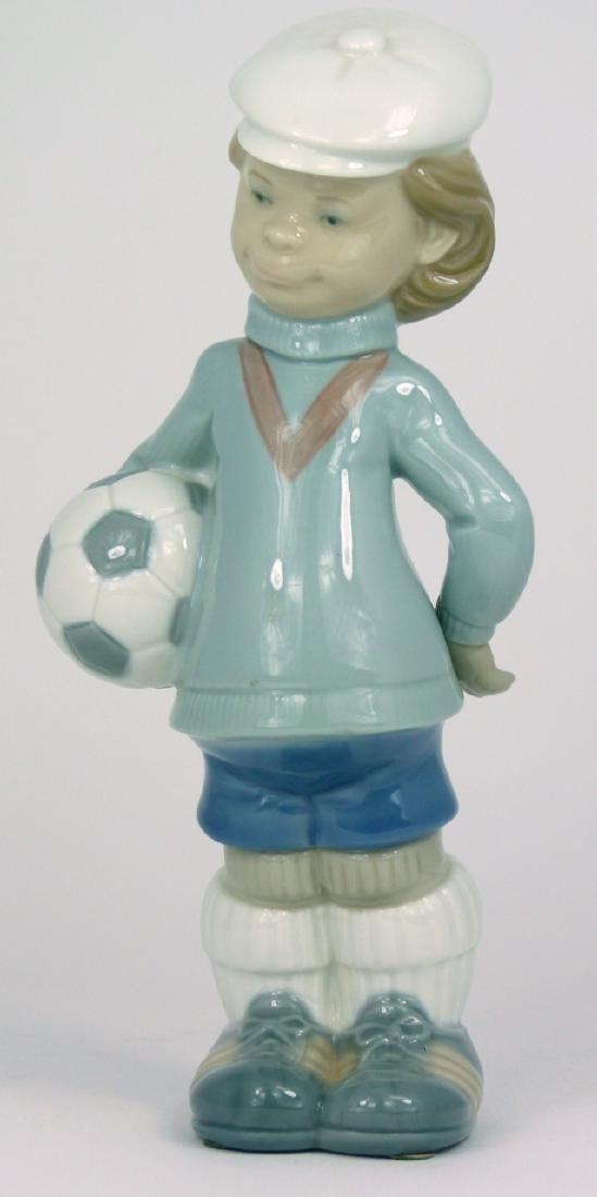 LLADRO 'SOCCER PLAYER PUPPET' PORCELAIN FIGURINE: Lladro porcelain figure depicting a boy with soccer ball #4967. Marked to underside. Measures 8 1/2" (21.5cm) height.