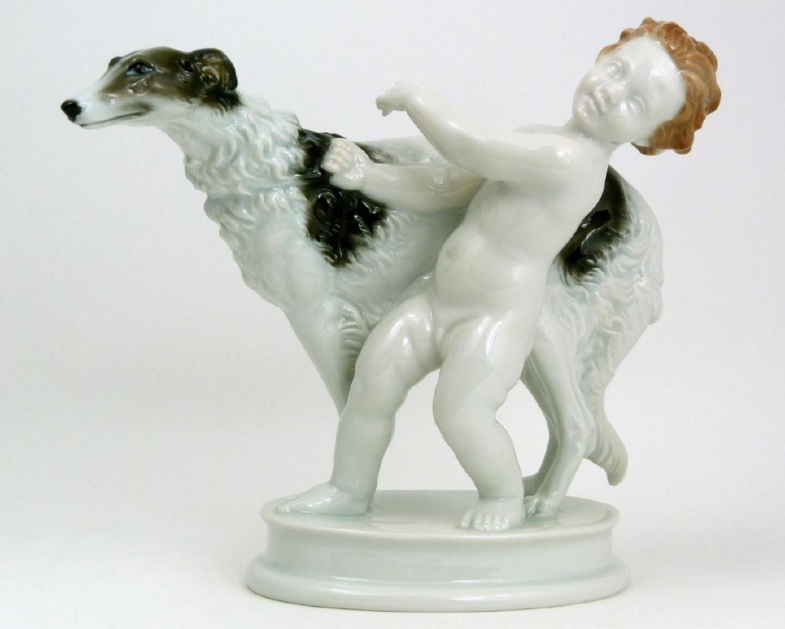 MAX FRITZ ROSENTHAL PORCELAIN BOY w DOG FIGURINE: Max Hermann Fritz Rosenthal porcelain figure depicting a putto with Borzoi dog. Impressed MF to top of base. Marked to underside. Measures 8" (20.3cm) length.