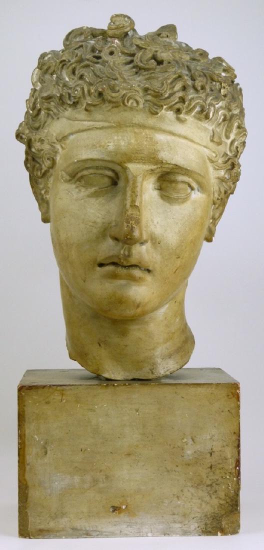 OLYMPIC GAMES GREEK ATHLETE BUST SCULPTURE: Sculpture depicting a Greek athlete from the ancient Olympic games. Appears to be made of plaster of Paris or similar. Measures 19" (48.2cm) height.