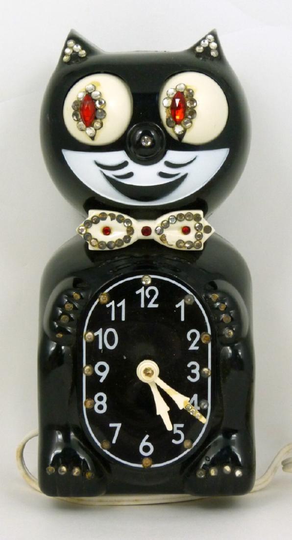 VINTAGE KIT CAT KLOCK JEWELED w BOX: Original Kit Cat Klock wall clock depicting Felix the cat with rhinestones and velvet felt to tail pendulum. California Clock Co. Marked to verso. Measures 8 1/4" (21cm) height excluding pendulum.