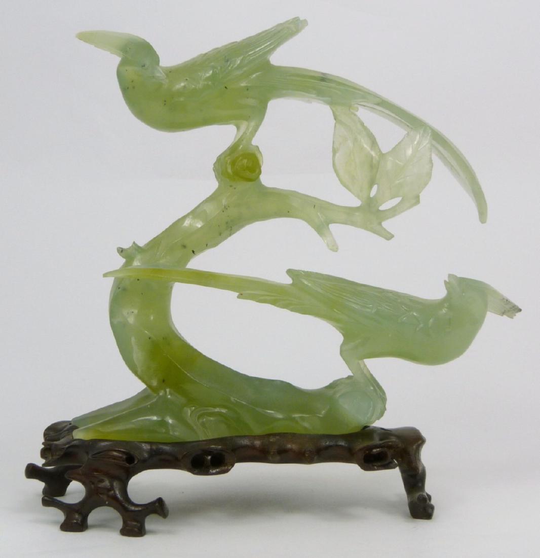 CHINESE CARVED SERPENTINE JADE BIRDS ON BRANCH: Chinese serpentine jade carving depicting tro birds on a branch. Measures 6" (15.2cm) height + 1" (2.5cm) wooden stand.