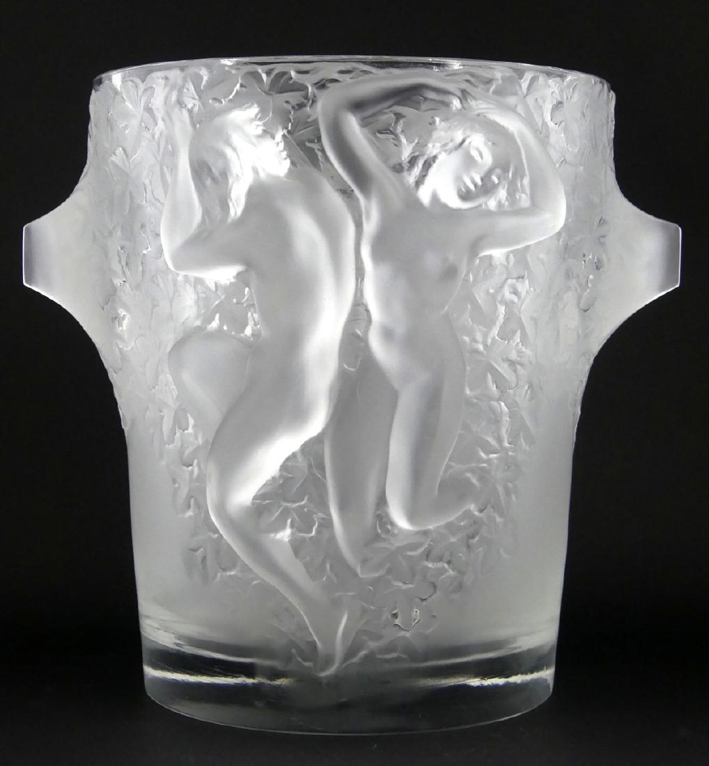 LALIQUE FRANCE "GANYMEDE" FROSTED CHAMPAGNE COOLER: Lalique French frosted crystal wine cooler ice bucket. Titled 'Ganymede'. Features frosted handled and raised figures in frosted relief with floral motif. Signed to underside. Measures 9" (22.8cm) hei