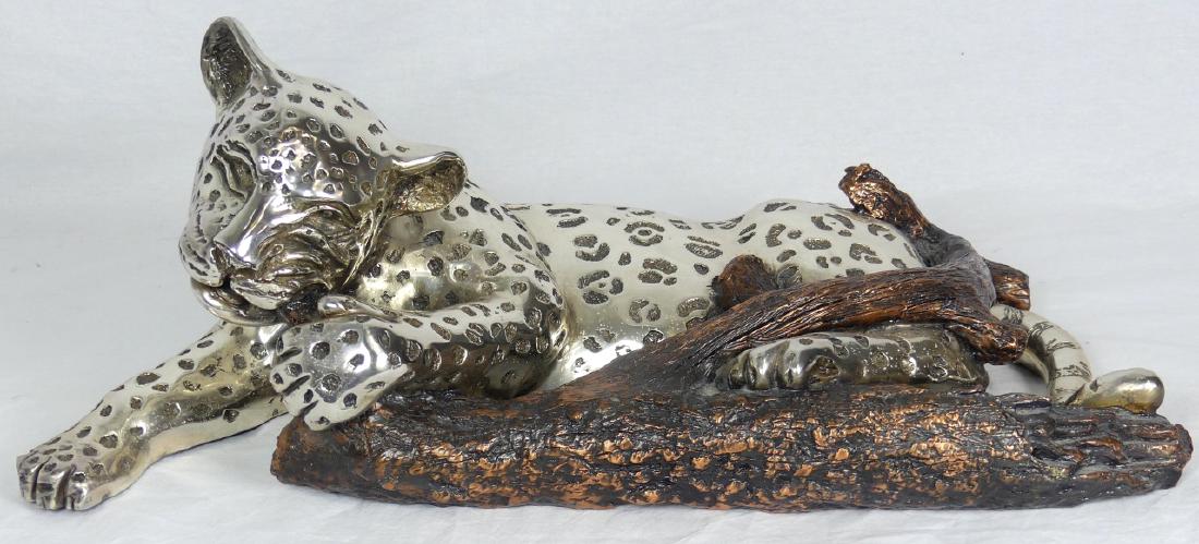 D'ARGENTA SILVER LEOPARD ON BRANCH SCULPTURE: D'argenta silver plated sculpture depicting a leopard reclining on tree branch. Designed by Enrique Jolly. Signed and numbered 30/500 to side near front right leg. Holds original labels to underside. 