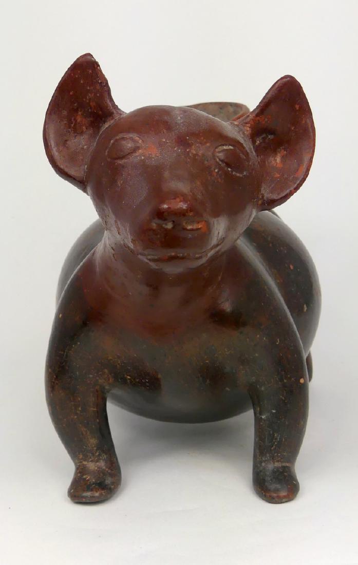 PRE-COLUMBIAN COLIMA DOG VESSEL: Pre-Columbian pottery dog vessel. Colima, Mexico. Circa 200 B.C.-400 A.D. Protoclassic Period. Measures 9 3/4" (24.8cm) length. Purchased from Gerald M. Sylvar Antiques, San Francisco, CA, 1978.