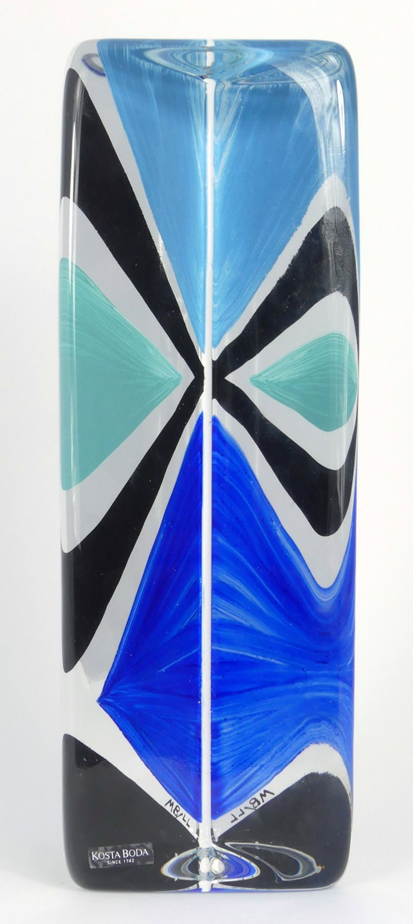 MONICA BACKSTROM KOSTA BODA TRIANGULAR SCULPTURE: Monica Backstrom for Kosta Boda glass sculpture of triangular form. Inscribed MB / LL and holds original label to lower side of sculpture. Inscribed Kosta Boda, M Backstrom and numbered to underside.