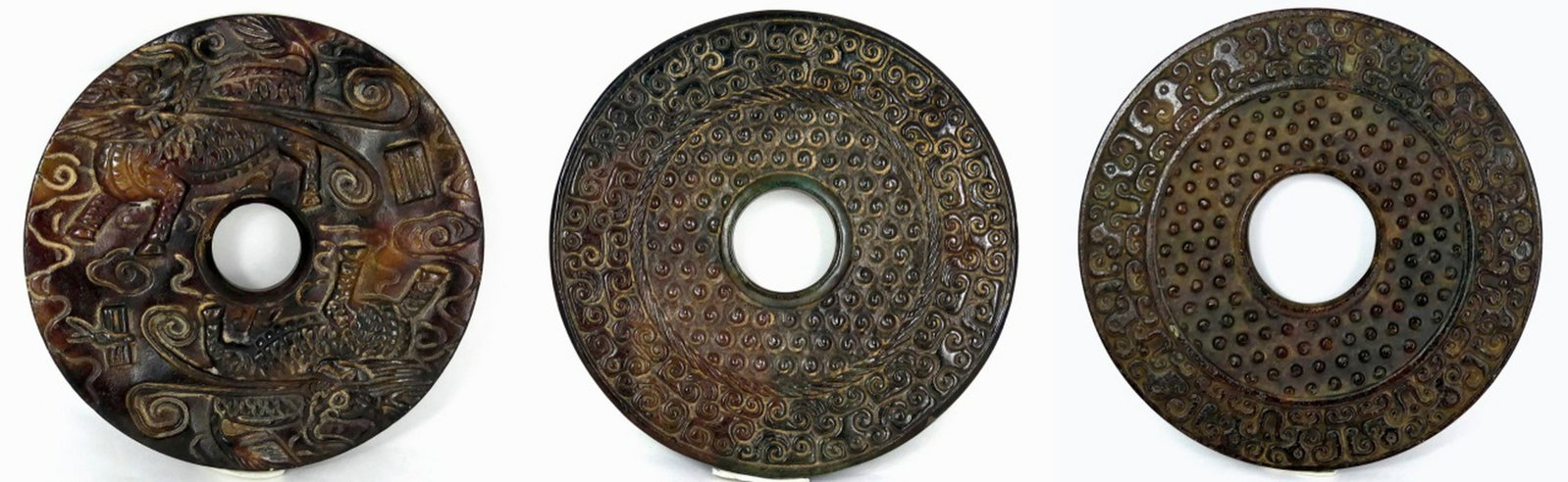 3pc CHINESE ARCHAISTIC JADE BI DISCS: 3 Chinese Archaistic jade bi discs carved in low relief. One decorated with Qilin and Taotie masks. Largest measures 4 3/4" (12cm) diameter.