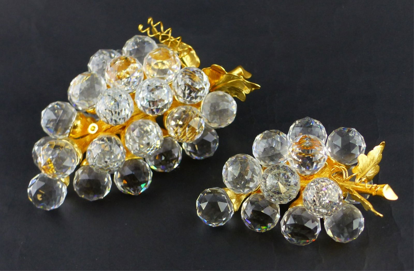 2pc SWAROVSKI CRYSTAL GRAPE CLUSTER FIGURES: 2 Swarovski grape bunch figures. Each marked to underside. Largest measures 5 3/8" (13.7cm) length.
