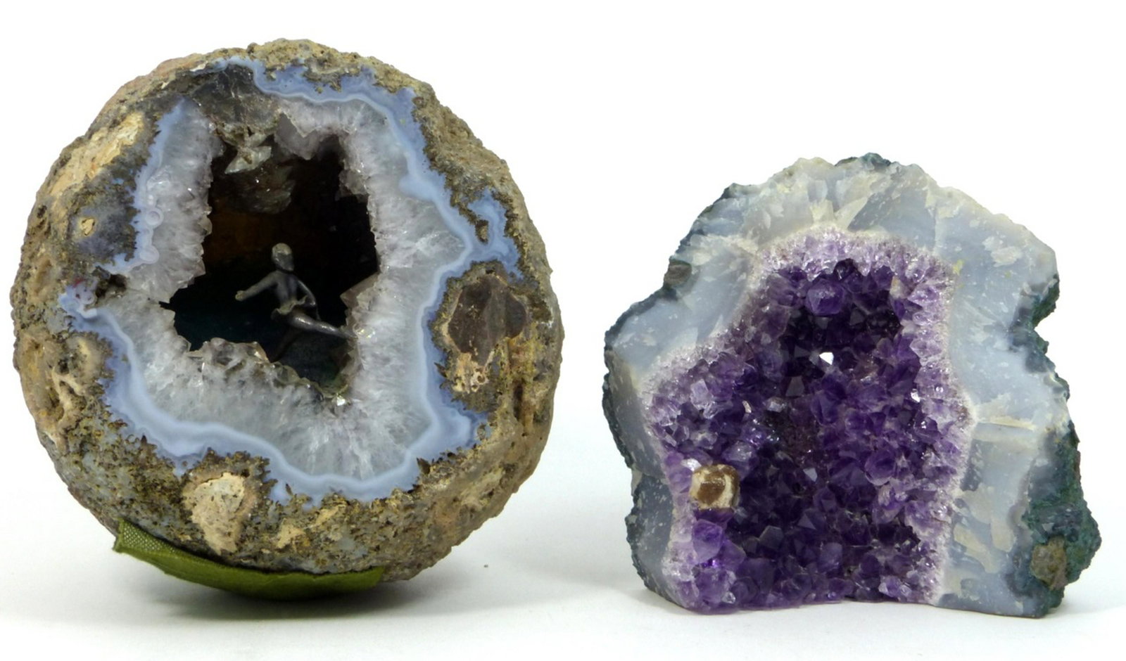 2pc GEODES AMETHYST & QUARTZ: Amethyst geode measures 4 1/4" (10.7cm) height and width. Clear quartz boulder geode has metal figure of a female ice skater mounted to "frozen water" and measures 5 1/2" (14cm) height.