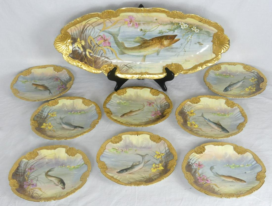 9pc LSS LIMOGES PORCELAIN FISH SET ARTIST SIGNED: 9 piece Lewis Straus & Sons Limoges French hand painted porcelain fish set with gilt borders. Includes 8 plates and large serving platter. Each marked to underside and signed 'Francis' below image. Pl