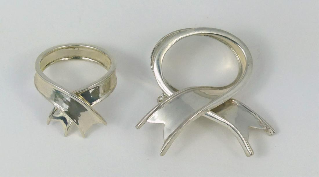 2pc TIFFANY STERLING SILVER 'RIBBON' RING & BROOCH: Tiffany & Company sterling silver ring and pin, each with ribbon design. Each marked T & Co, 925. Ring size 6. Brooch measures 1 1/4" (3.1cm) height and width.