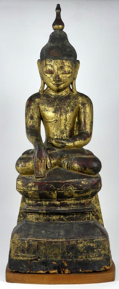 ANTIQUE THAI HAND CARVED GILT WOOD BUDDHA: Antique Thai hand carved gilt wood Buddha sculpture. Mounted on wooden plank. Measures 21 1/2" overall height.