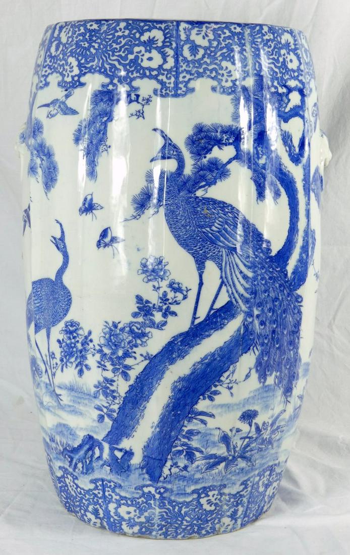 CHINESE BLUE & WHITE PORCELAIN GARDEN SEAT: Chinese blue and white porcelain garden seat with mask handles. Depicts a landscape scene with flowers and birds. Measures 19 1/2" height x 12" width.