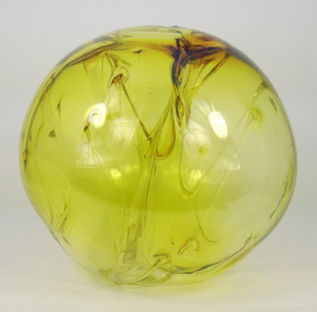 PETER BRAMHALL SPHERICAL ART GLASS SCULPTURE: Peter Bramhall (American, 20th C) studio art glass sculpture in the form of a sphere / orb with internally structured decoration. Amber in color. Signed and dated to underside. Measures 9 1/2" height
