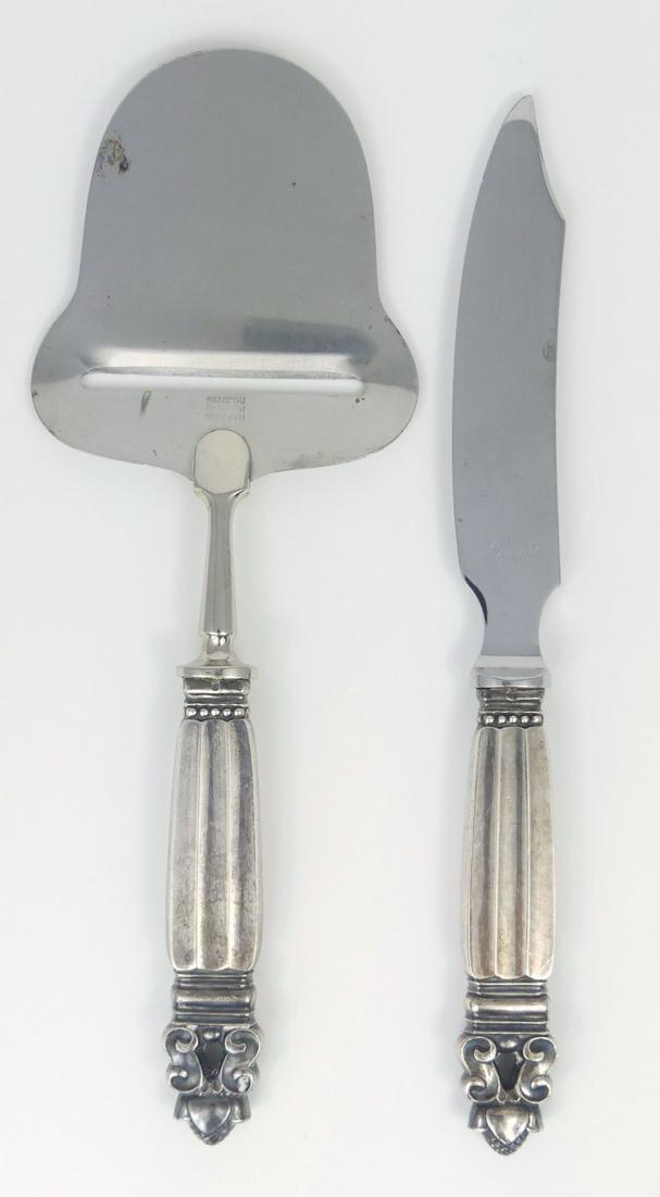 2pc GEORG JENSEN 'ACORN' CHEESE SET: 2 pieces of Georg Jensen sterling silver in the "Acorn' pattern. Include Cheese plane and Cheese knife. Each hallmarked and marked Denmark, Sterling. Circa 1910-1925. Largest measures 8 1/4" length.