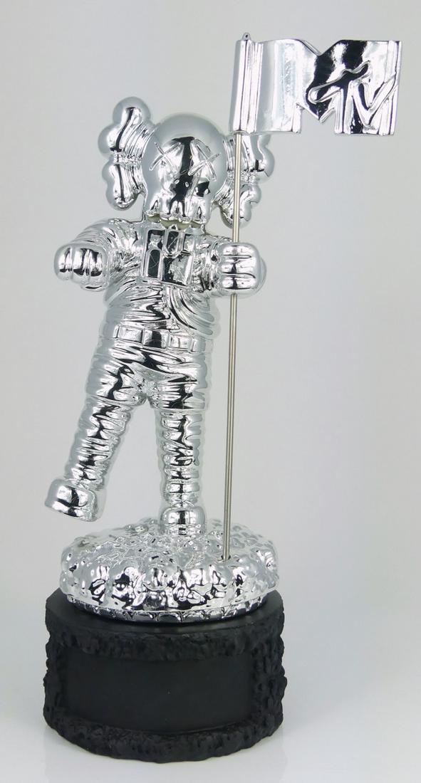 KAWS MTV MOONMAN SCULPTURE: Kaws aka Brian Donnelly (American, b. 1974) chrome sculpture of the MTV video music awards moonman trophy. Raised on a black rock-form base. Measures 12" overall height.
