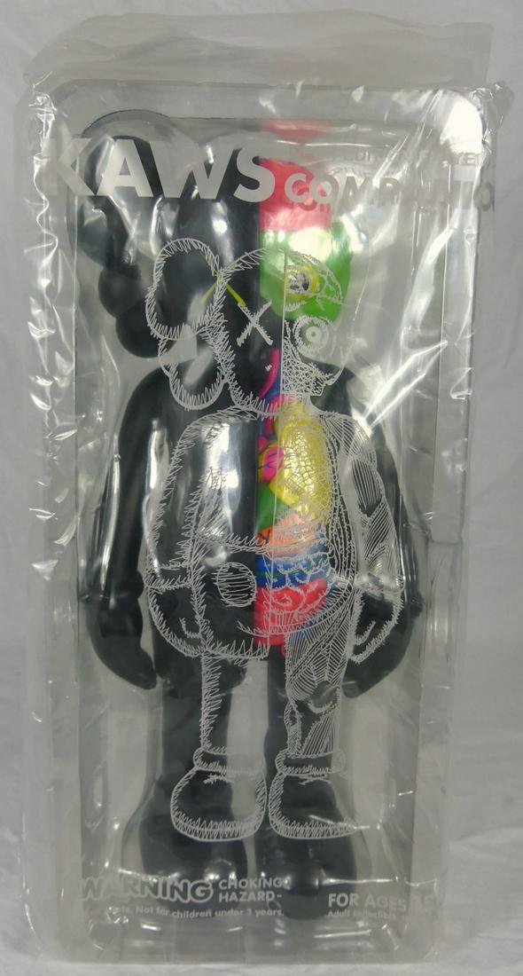 KAWS FLAYED DISSECTED COMPANION BLACK 2006: KAWS aka Brian Donnelly (American, b. 1974) Flayed Dissected Companion in black. Painted cast vinyl. Marked Medicom Toy 2006 China and c. KAWS..06. Figure measures 14 1/2" height. Sealed in original p