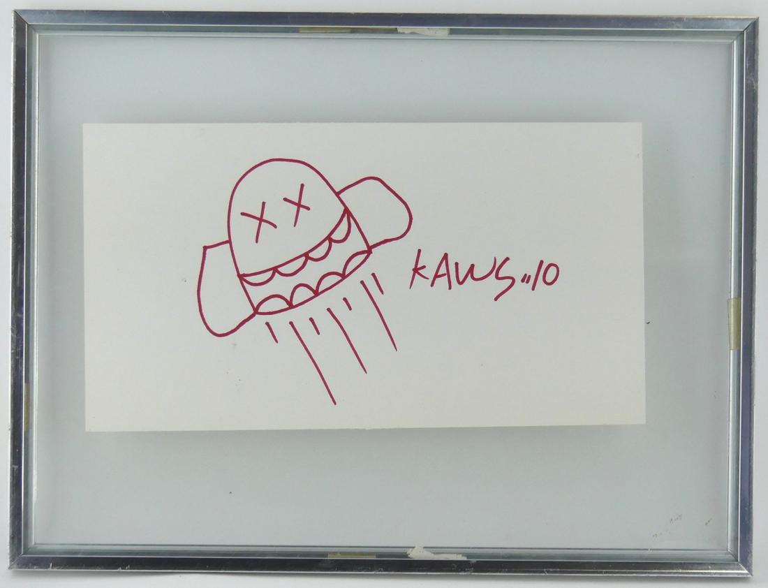 KAWS MARKER DRAWING ON PAPER: Kaws aka Brian Donnelly (American, b. 1974) red marker drawing on paper. Signed center right. Sheet 12" x 6 1/2". Frame measures 16" x 12".