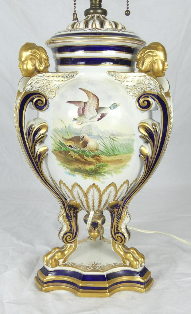 CONTINENTAL COBALT & GILT PORCELAIN LAMP: Continental cobalt and gilt porcelain lamp having three winged head handles and paw feet. Three hand painted scenes including mallard ducks, fruit and flowers. Porcelain measures 15 1/4" height. Lamp