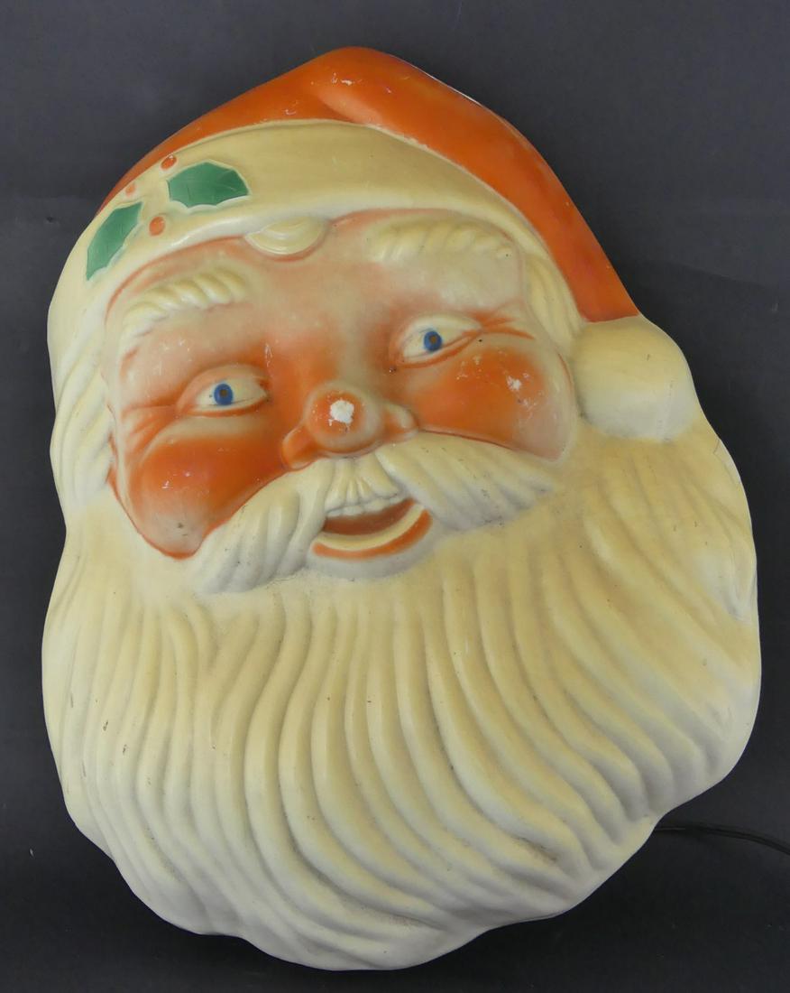 VINTAGE LIGHTED SANTA CLAUS HEAD CHRISTMAS DECO: Vintage illuminated Santa Claus head hanging wall decoration. Circa 1950's to 1960's. Probably Noma. Measures 16" height.