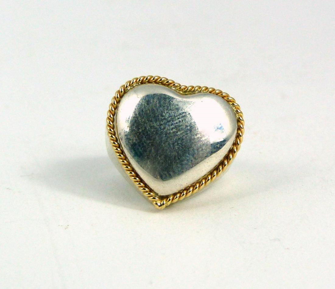 TIFFANY & CO STERLING SILVER & 14kt YG HEART RING: Tiffany & Company sterling silver ring in the form of a heart with 14kt yellow gold twisted border. Heart measures approx 18mm width. Ring size 4. Marked to inside.