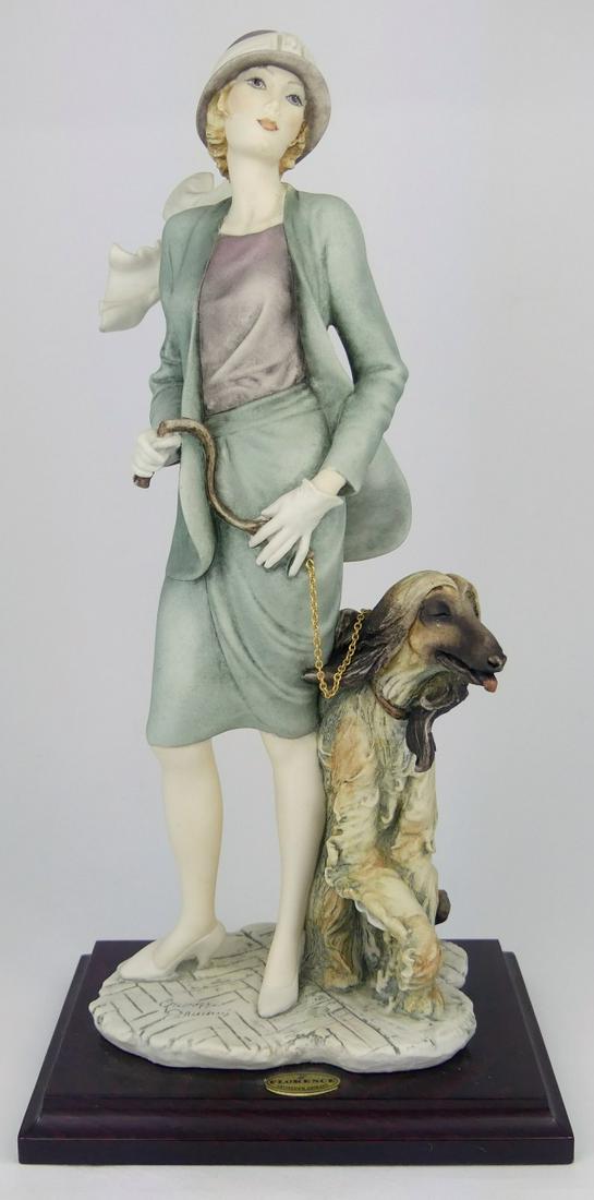GIUSEPPE ARMANI LADY w DOG FIGURINE: Giuseppe Armani figure depicting a lady with large seated dog on leash. Marked to base. Measures 14 3/4" height.