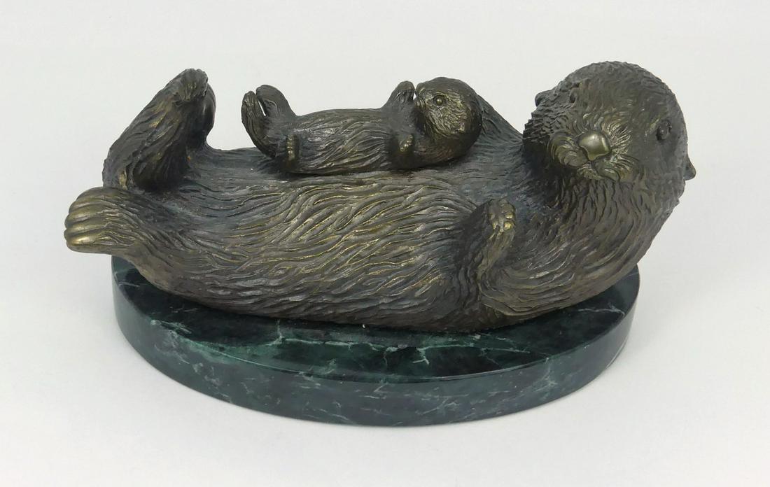 JERRY WARNER 'OTTER & PUP' BRONZE SCULPTURE: Jerry Warner (American, b. 1941) bronze sculpture depicting an otter with pup. Mounted on marble base. Signed and numbered 11/550. Measures 6" length.