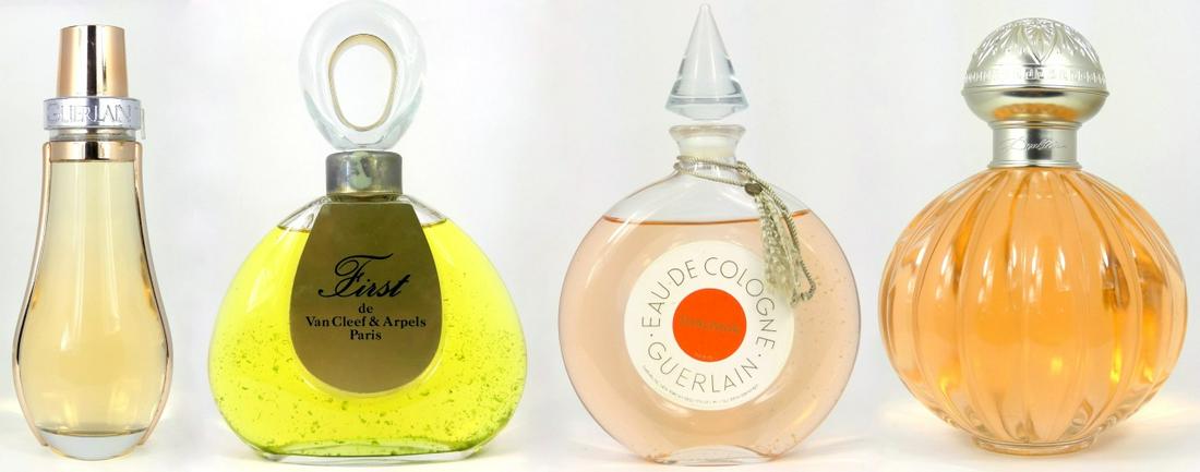 4pc FACTICE PERFUME BOTTLES: Four glass factice perfume bottles including Van Cleef and Arpels First, Guerlain Coriolan, Guerlain Shalimar eau de cologne and Doulton by Royal Doulton. Largest measures 15 1/2" height.