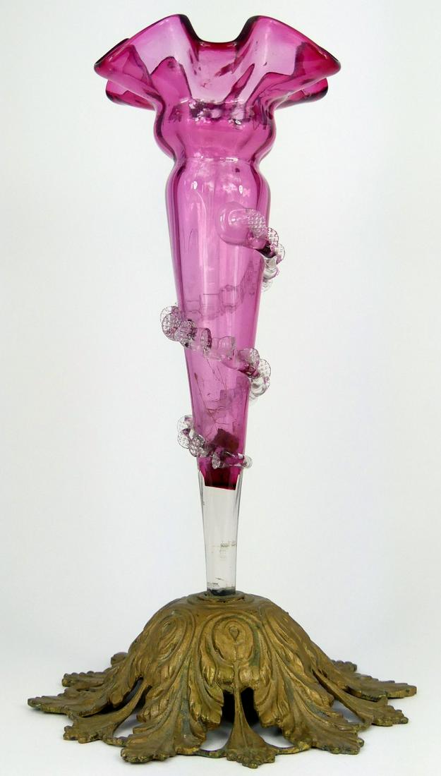 VICTORIAN CRANBERRY GLASS VASE w GILT METAL MOUNT: Victorian cranberry glass vase with colorless spiral ribbon decoration with gilt metal base. Measures 11 1/2" height.