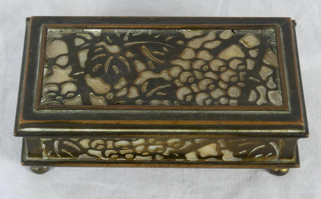 TIFFANY STUDIOS 'GRAPEVINE' BRONZE STAMP BOX: Tiffany Studios bronze and slag glass stamp box in the 'Grapevine' pattern. Marked Tiffany Studios, New York and numbered 801. Measures 4" length x 2 1/8" width.