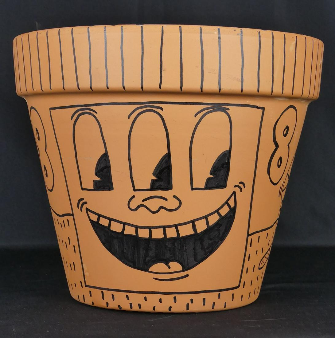 KEITH HARING TERRACOTTA POT: Keith Haring [attributed] black marker on terracotta flower pot. Depicts a three-eyed monster, 2 snakes and dog with ten legs and human-like head. Signed, dated 1988 and inscribed 'For Sam' to undersi