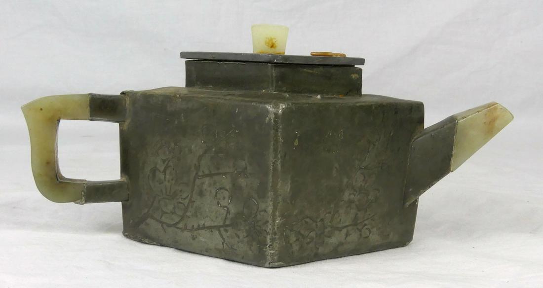 CHINESE PEWTER & JADE TEAPOT: Chinese pewter and jade teapot. Decorated with floral branches and calligraphy. Marked to inside. Holds remnants of wax seal to lid. Measures 7 1/4" length.