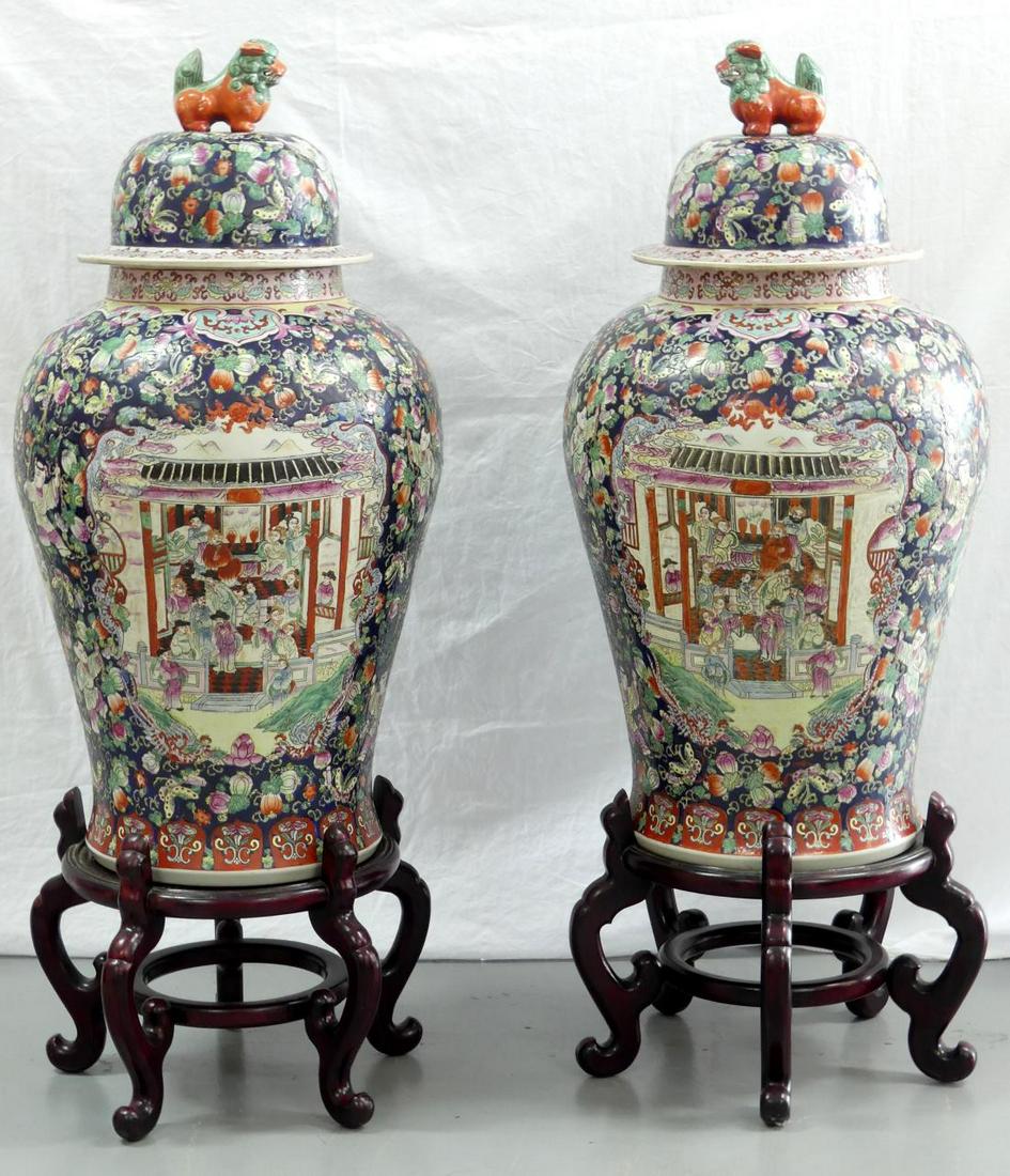PR LARGE CHINESE PORCELAIN TEMPLE JARS: Pair of large Chinese porcelain covered temple jars. Each having two large panels and two smaller panels decorated with figural scenes. Decorated with children and stylized vines with fruit throughout
