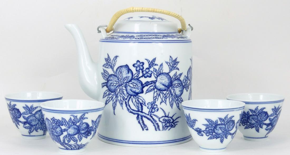 5pc CHINESE PORCELAIN BLUE & WHITE TEA SET: Five pieces Chinese blue and white porcelain tea set including teapot and 4 teacups. Each decorated with peaches and bats. Each marked to underside. Includes fitted basket with cover. Teapot measures 