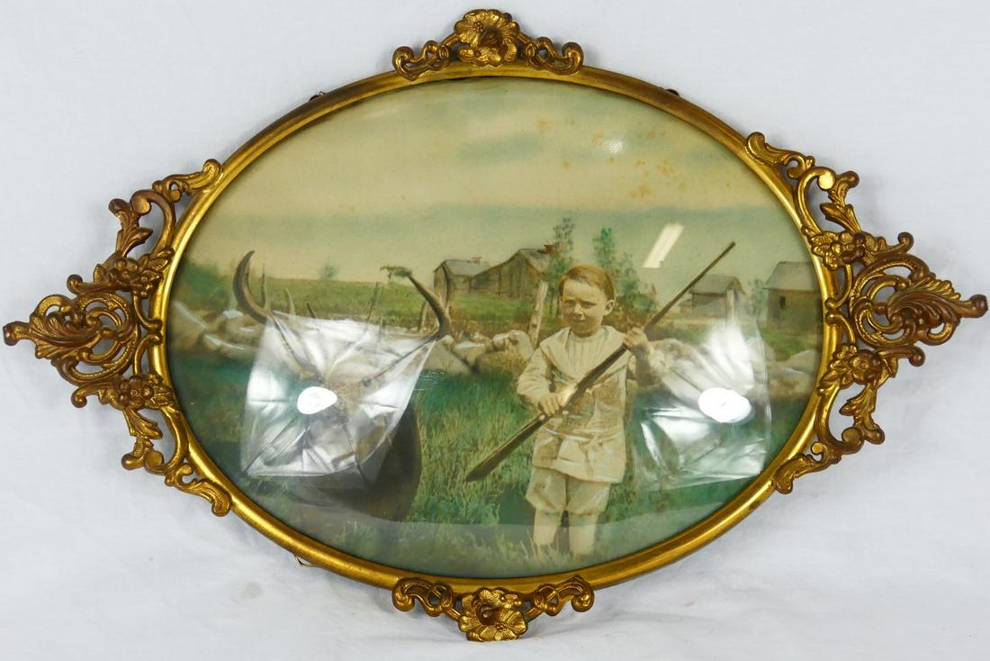 OVAL BRASS FRAME WITH BUBBLE GLASS: Oval brass frame with bubble glass. Measures 19 1/2" x 13".