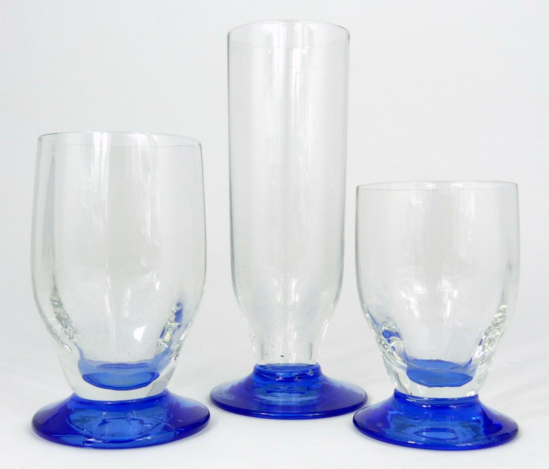 36pc DAUM NANCY COBALT & CLEAR CRYSTAL GOBLETS: 36 Daum Nancy cobalt and clear crystal goblets including 12 champagne, 12 sherry and 12 cordials. Each marked Daum Nancy to underside. Largest measures 5" height.