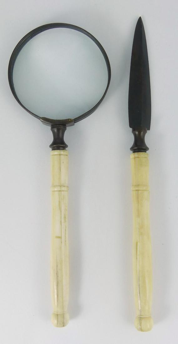 2pc BRASS & BONE DESK SET: 2 piece patinated brass and carved bone desk set including handled magnifying glass and letter opener. Largest measures 9 1/4" length.
