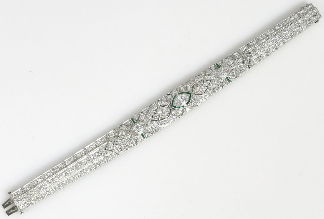 ART DECO PLATINUM DIAMOND & EMERALD BRACELET: Lady's Art Deco platinum, diamond and emerald bracelet. Marquise cut center diamond measures approx 8mm x 4.5mm, flanked by two additional marquise cut diamonds measuring approx 7.5mm x 3.5mm. Plus ap