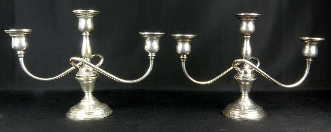 PR INTERNATIONAL STERLING 'BERKELEY' CANDELABRA: Pair of International Sterling Silver 3-light candelabra in the 'Berkeley' pattern. Can be converted for use as single candle holders. Each marked to underside and measures 13" width x 8 3/4" height.