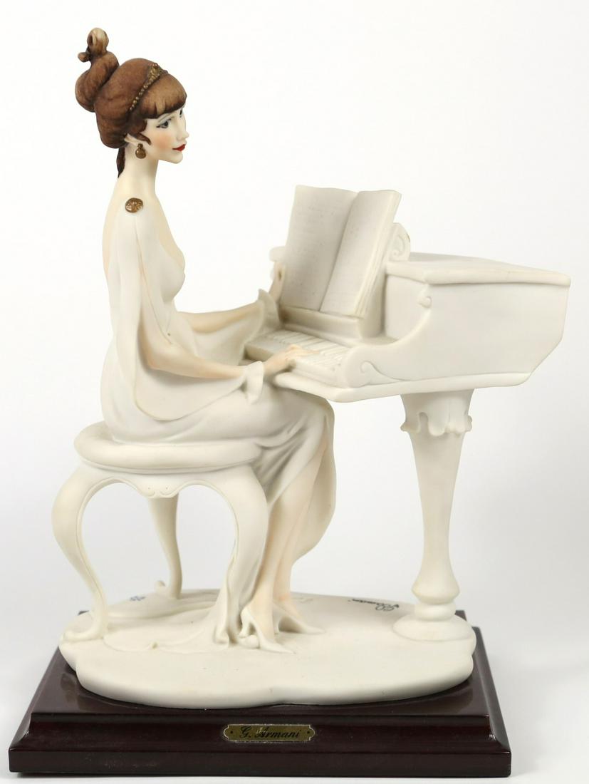 GIUSEPPE ARMANI 'LADY AT PIANO' FIGURINE: Giuseppe Armani figure depicting a lady seated at piano. Marked to base. Measures 10 1/2" height x 8" length.