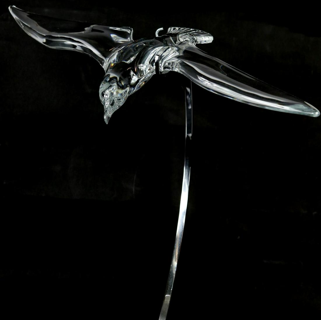 DAUM 'BIRD IN FLIGHT' CRYSTAL SCULPTURE w STAND: Daum French crystal sculpture depicting a bird in flight. Signed Daum France to side of body. Wingspan measures 21 1/2". Stand measures 18" height.